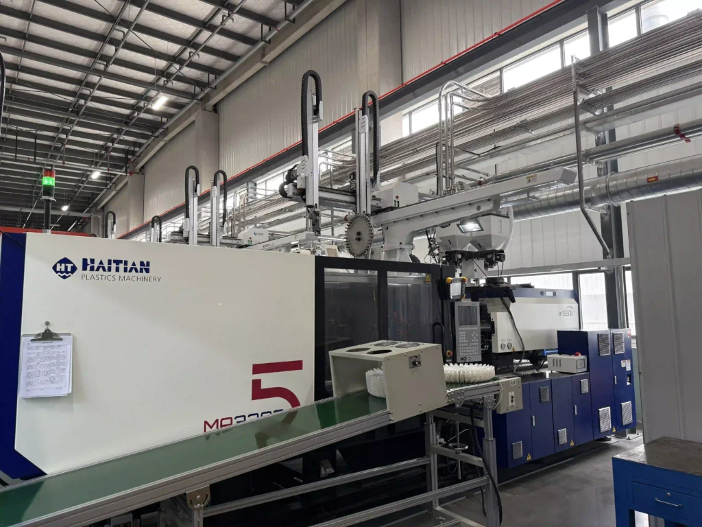 Molded product discharge outet from disposable cutlery production line