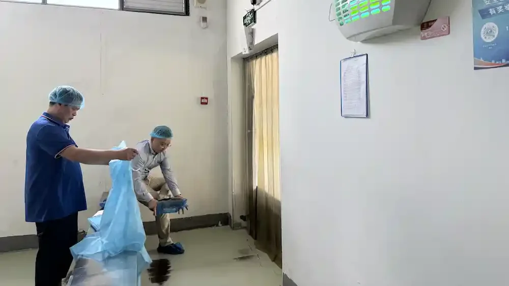 Worker changing work clothes before disposable paper cup production